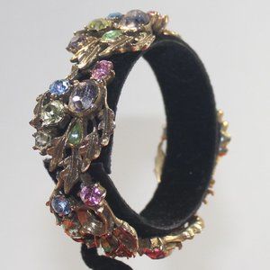 Lisner hinged gold tone bracelet with pastel rhinestones